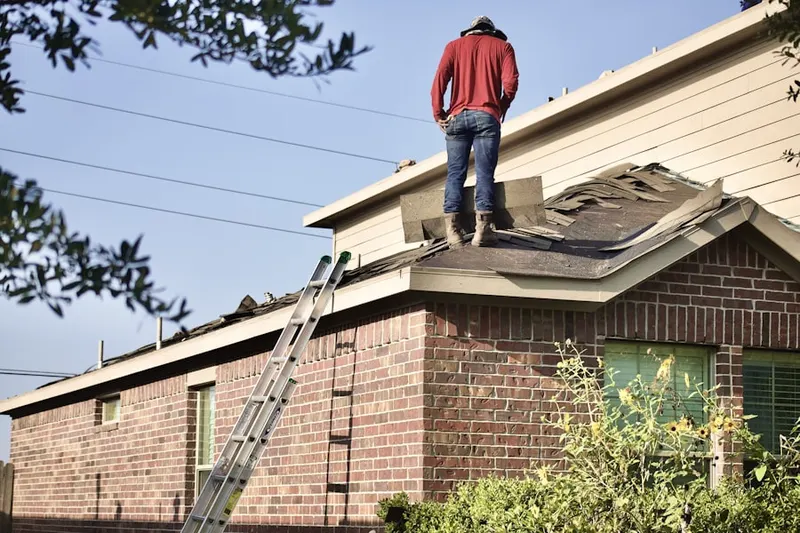 Professional roofer working on a residential roof in Lofty Heights